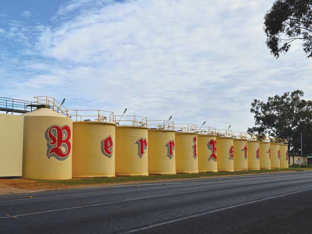 Yellow wine tanks labelled with Berri Estates in red cursive writing