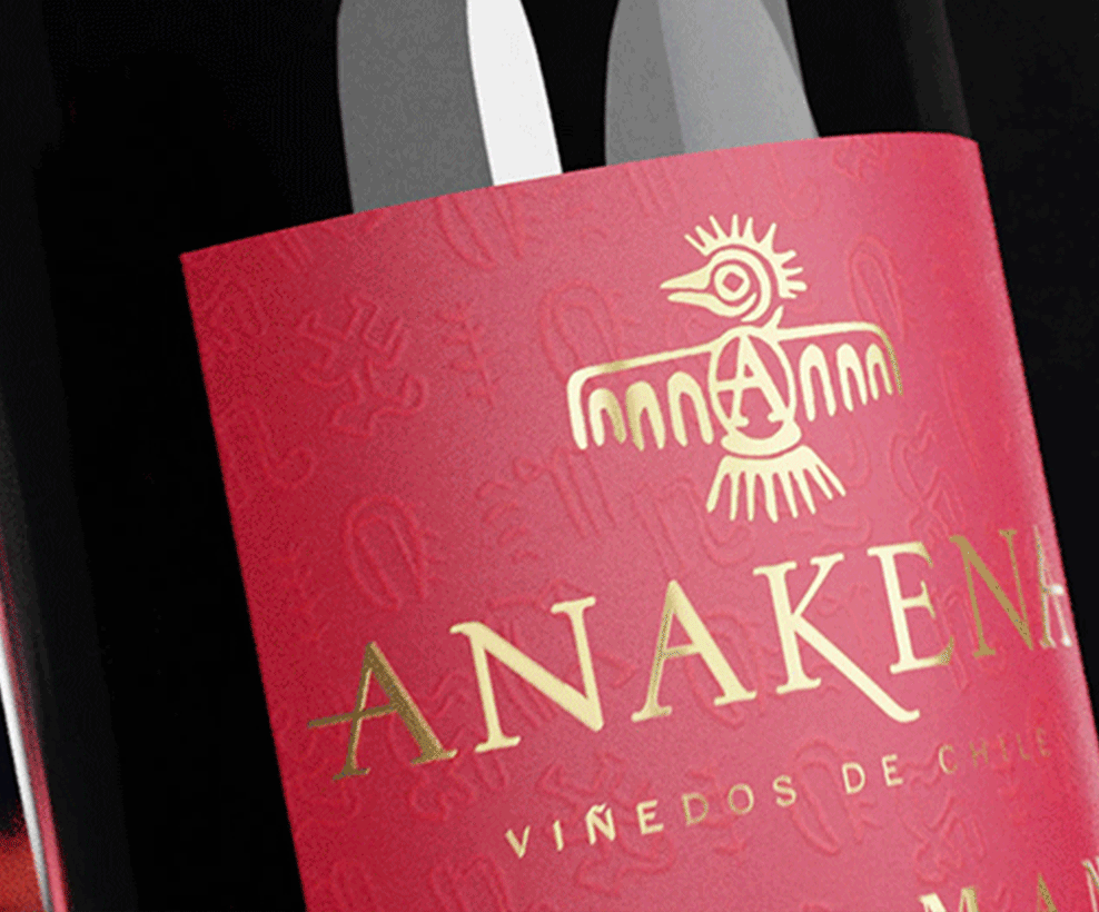 Product shot of an Anakena red wine bottle with red and gold label on the front