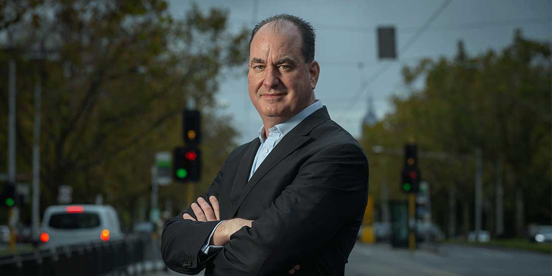 accolade wine ceo robert foye stands on a street with his arms crossed