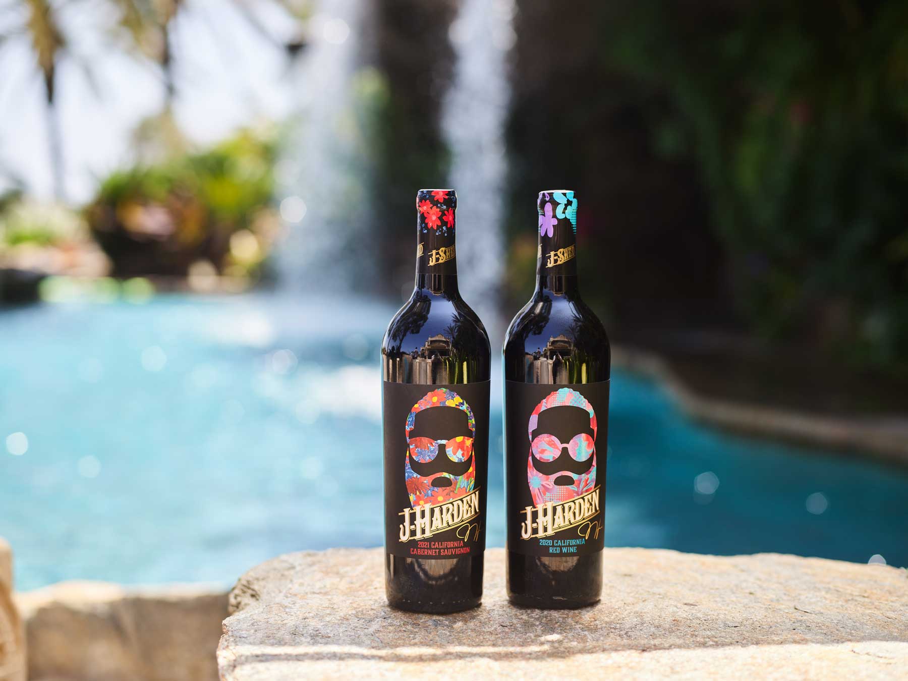two bottles of J-Harden x J-Shed wine in front of a pool