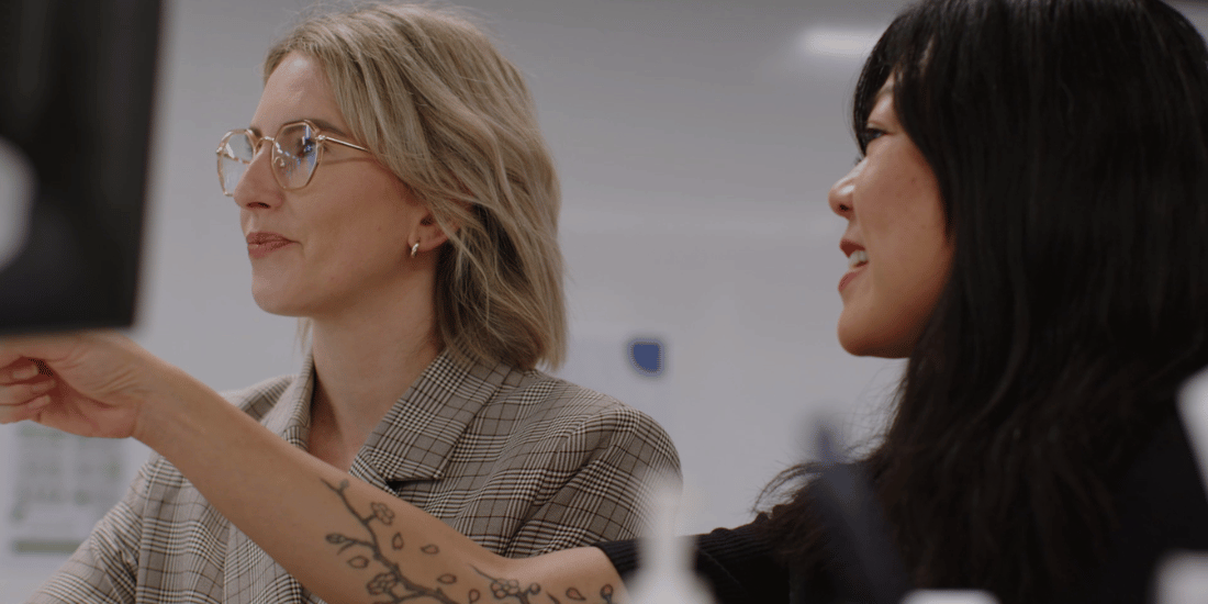 Two women looking at a computer screen